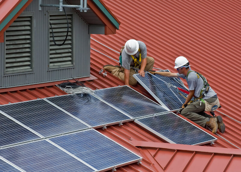 Experts installing Solar Panels on a roof